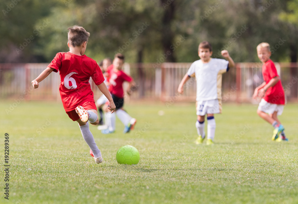 Young children players football match on soccer field